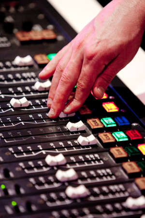 A man adjusts audio settings during a radio broadcastの写真素材