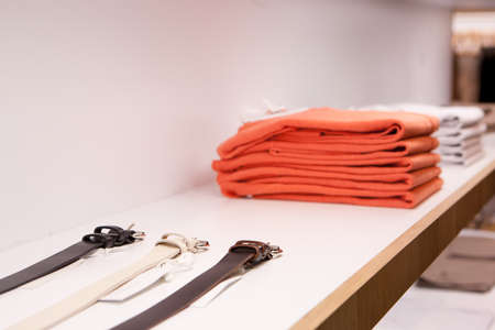 Clothes hang on a shelf in a designer clothes store in Melbourne, Australiaの写真素材