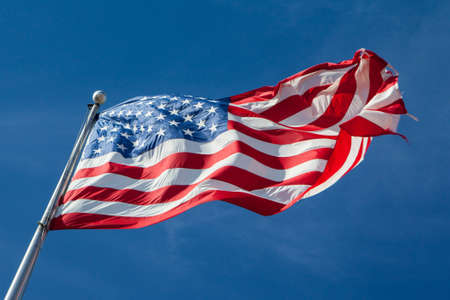 A USA flag flies in a strong wind in Louisiana, USAの写真素材