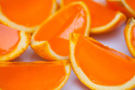 Jelly slices in orange peel on a plate at a childrenの写真素材