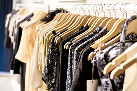 Clothes hang on a shelf in a designer clothes store in Melbourne, Australiaの写真素材