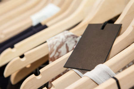 Clothes hang on a shelf in a designer clothes store in Melbourne, Australiaの写真素材