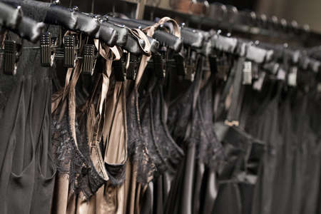 Clothes hang on a shelf in a designer clothes store in Melbourne, Australiaの写真素材
