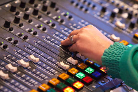 A lady adjusts audio settings during a radio broadcastの写真素材