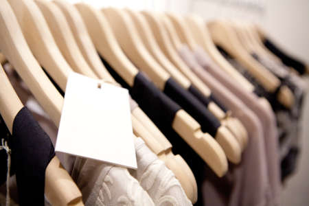 Clothes hang on a shelf in a designer clothes store in Melbourne, Australiaの写真素材