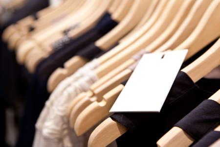 Clothes hang on a shelf in a designer clothes store in Melbourne, Australiaの写真素材
