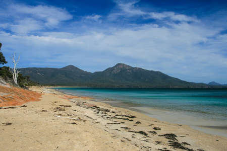 A beach in a remote part of the Freycinet Peninsula in Tasmaniaの写真素材