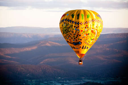A sunrise hot air balloon flight over the Yarra Valley in Victoria, Australiaの写真素材