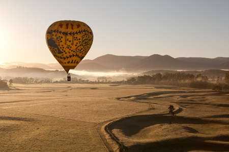 A sunrise hot air balloon flight over the Yarra Valley in Victoria, Australiaの写真素材
