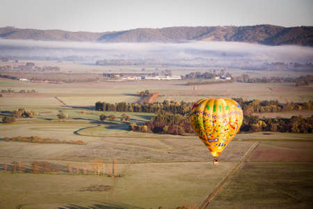 A sunrise hot air balloon flight over the Yarra Valley in Victoria, Australiaの写真素材