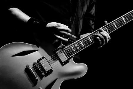 A guitarist tunes his guitar before playing in Melbourne, Australiaの写真素材