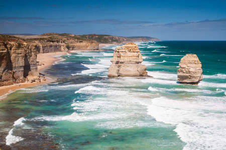 Some of the Twelve Apostles shine in the afternoon sun on a hot summer's day near Port Campbell, Victoria, Australiaの写真素材