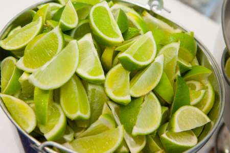 A bucket of limes for cocktails at a partyの写真素材