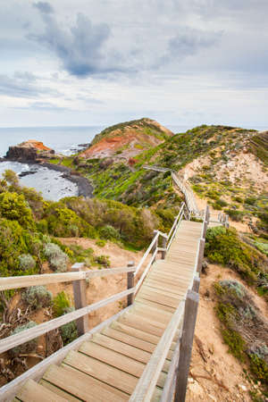 The famous Cape Schanck boardwalk runs towards the sea and rock formation known as London Bridge, in Victora. Australiaの写真素材