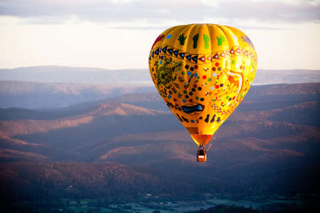 A sunrise hot air balloon flight over the Yarra Valley in Victoria, Australiaの写真素材