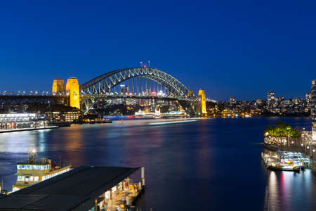 Boat traffic around Sydney harbour Bridge at rush hour on a winter's evening in Sydney, Australiaの写真素材