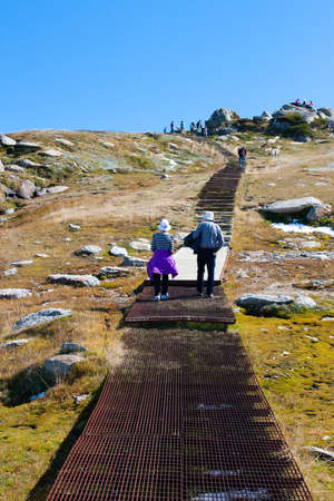 Hikers walk on the Kosciuszko walk near the summit of Thredo in Snowy Mountains, New South Wales, Australiaの写真素材