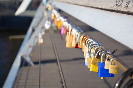Padlocks hang on Melbourne's famous Southbank Pedestrian Bridge as signs of love in Victoria,...