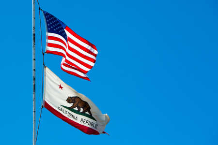 The USA and California state flags on Strawberry Peak near Twin Peaks, Califonia, USAの写真素材