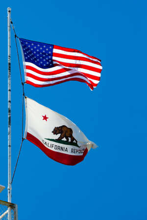 The USA and California state flags on Strawberry Peak near Twin Peaks, Califonia, USAの写真素材