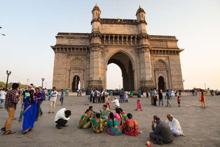 Mumbai, India - 9 November: The Gateway of India with tourists and sellers on a clear autumn eveningのeditorial素材