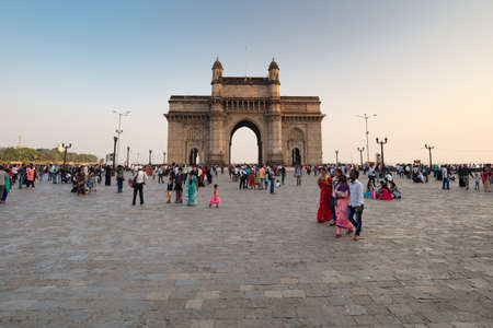 Mumbai, India - 9 November: The Gateway of India with tourists and sellers on a clear autumn eveningのeditorial素材