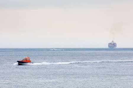 An iconic Port Philip Pilot boat helps to bring large ships thru 'The Rip' at the heads of Port...
