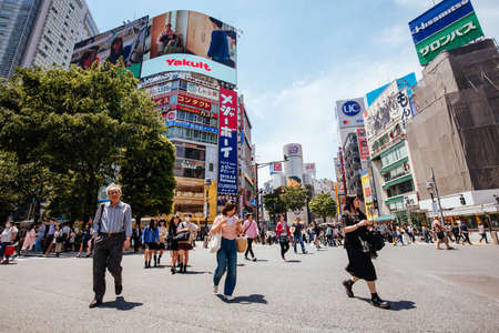 TOKYO, JAPAN - MAY 11, 2019 - People walk over Shibuya Crossing which is one of the world's most used pedestrian crossings, in central Tokyo, Japanのeditorial素材