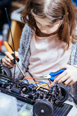 Young Female Child Soldering New Motor Leads
