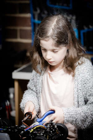 Young Female Child Soldering New Motor Leads