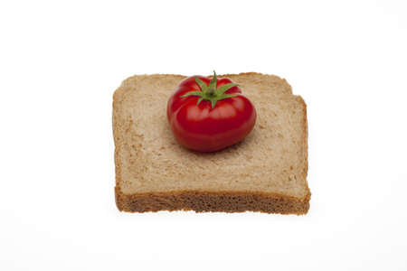 A small tomato on a slice bread for toasty of total millingの写真素材
