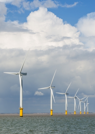wind power generators farm at sea with stormy clouds の写真素材
