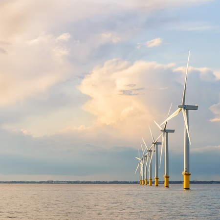 wind power generators farm at sea with stormy clouds の写真素材