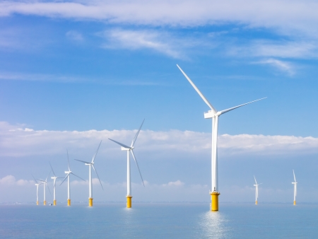 wind power generators farm at sea with white clouds and blue skyの写真素材