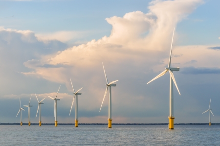 wind power generators farm at sea with stormy cloudsの写真素材