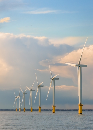 wind power generators farm at sea with stormy cloudsの写真素材