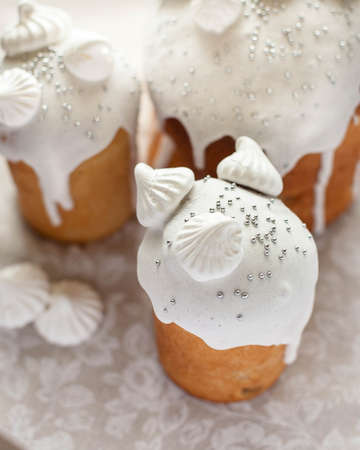 Festive cake with white frosting decorated with merengue