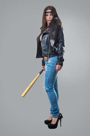 Athletic girl in the image of the street fighter from a computer game with a baseball bat in his hand.の写真素材