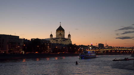 Illuminated Pleasure boat sails across Moscow River at nightの写真素材