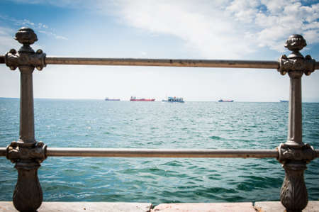 Greece, Thessaloniki, about july 2015 Tankers in harbor, viewed through the barsの写真素材