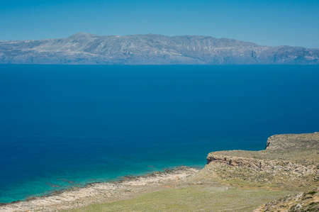 Sea coast, turquoise water and rocky hill. Road to Balos, Crete, Greeceの写真素材