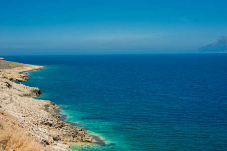 Sea coast, turquoise water and rocky hill. Road to Balos, Crete, Greeceの写真素材