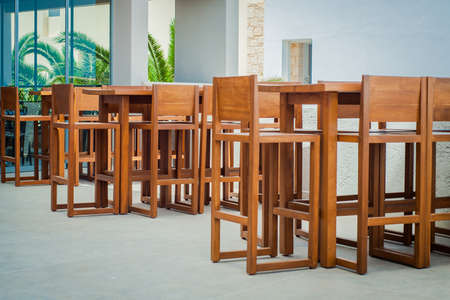 Wooden tables and chairs in seaside restaurantの写真素材