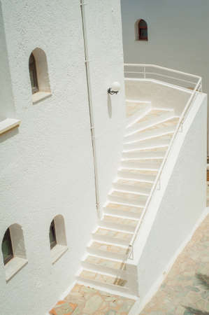 Greek architecture - white buildings, sea and blue windowsの写真素材