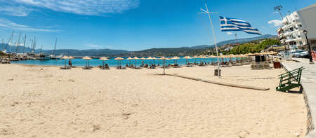 Greece, Crete, Agios Nikolaos beach with greece flagのeditorial素材