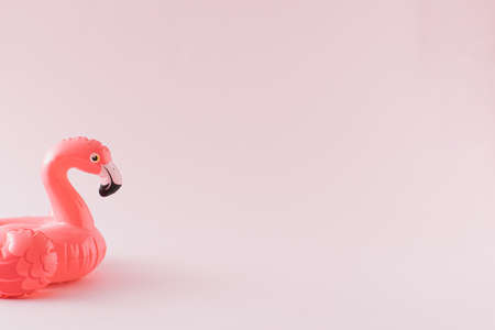 Pink flamingo toy on pastel pink background. Minimal summer concept.の写真素材