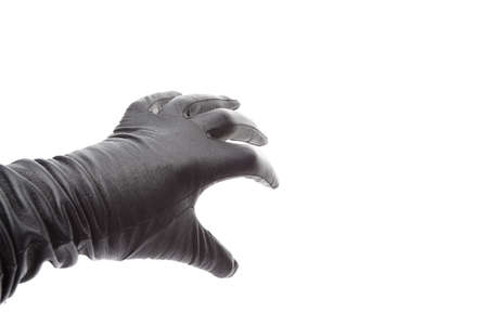 Hand in black leather gloves takes somethingの写真素材