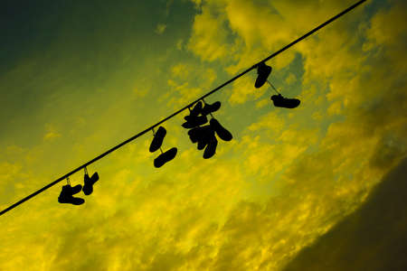 Shoes on a wire at the Prague Metronome, Czech Republicの写真素材