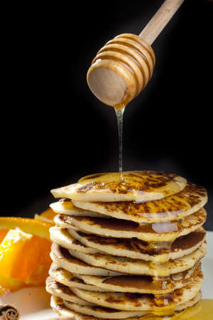 Pancake with honey on black background