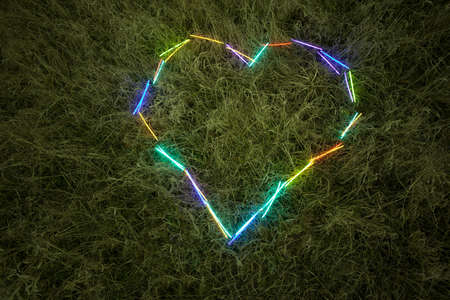 Glowing heart in grass